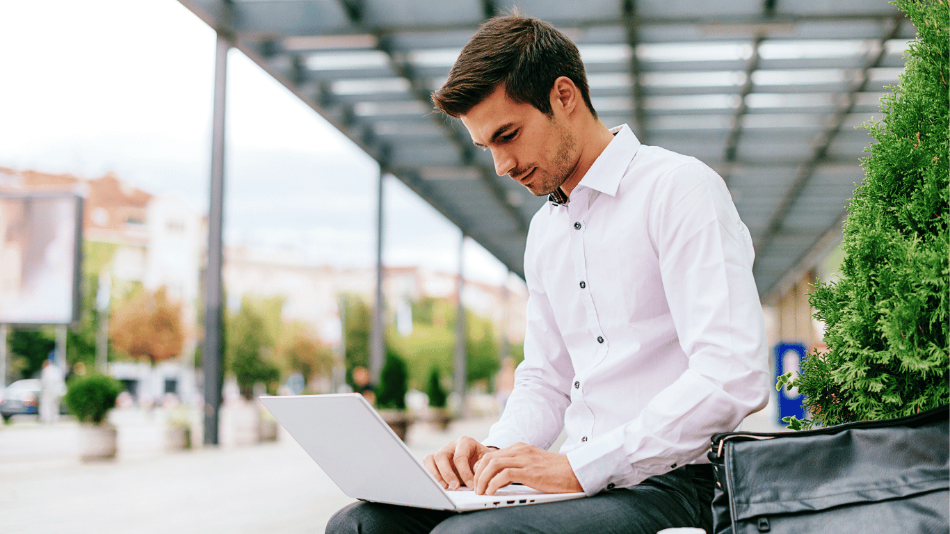 Hybrid employee using a laptop on public Wi-Fi with risk indicators